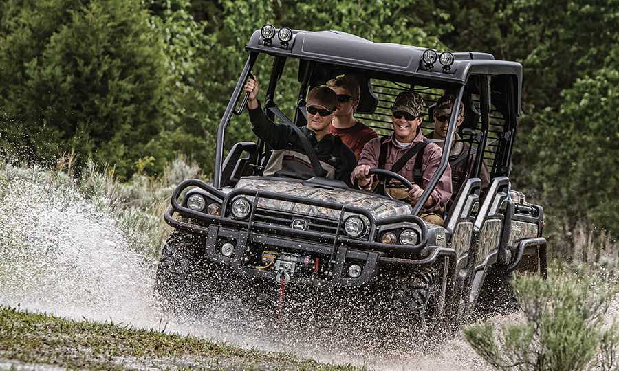 Men driving a John Deere XUV Series Gator