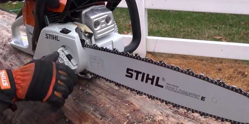 Man tightening the chain on his STIHL chainsaw with the Quick Chain Adjuster feature